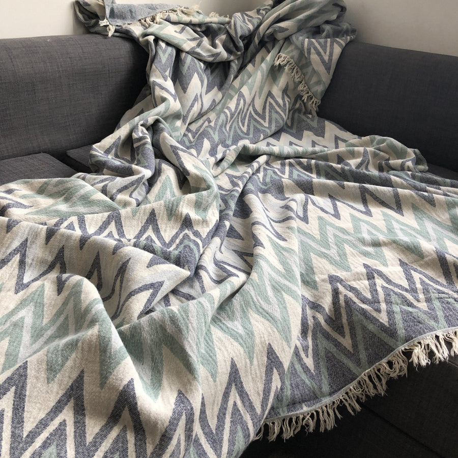 Luxury Sirocco organic cotton jacquard weave throw, oversized 200x250cm, soft muted green blue grey zigzag pattern, premium bedspread or sofa blanket by Wildash London at brixbailey.com