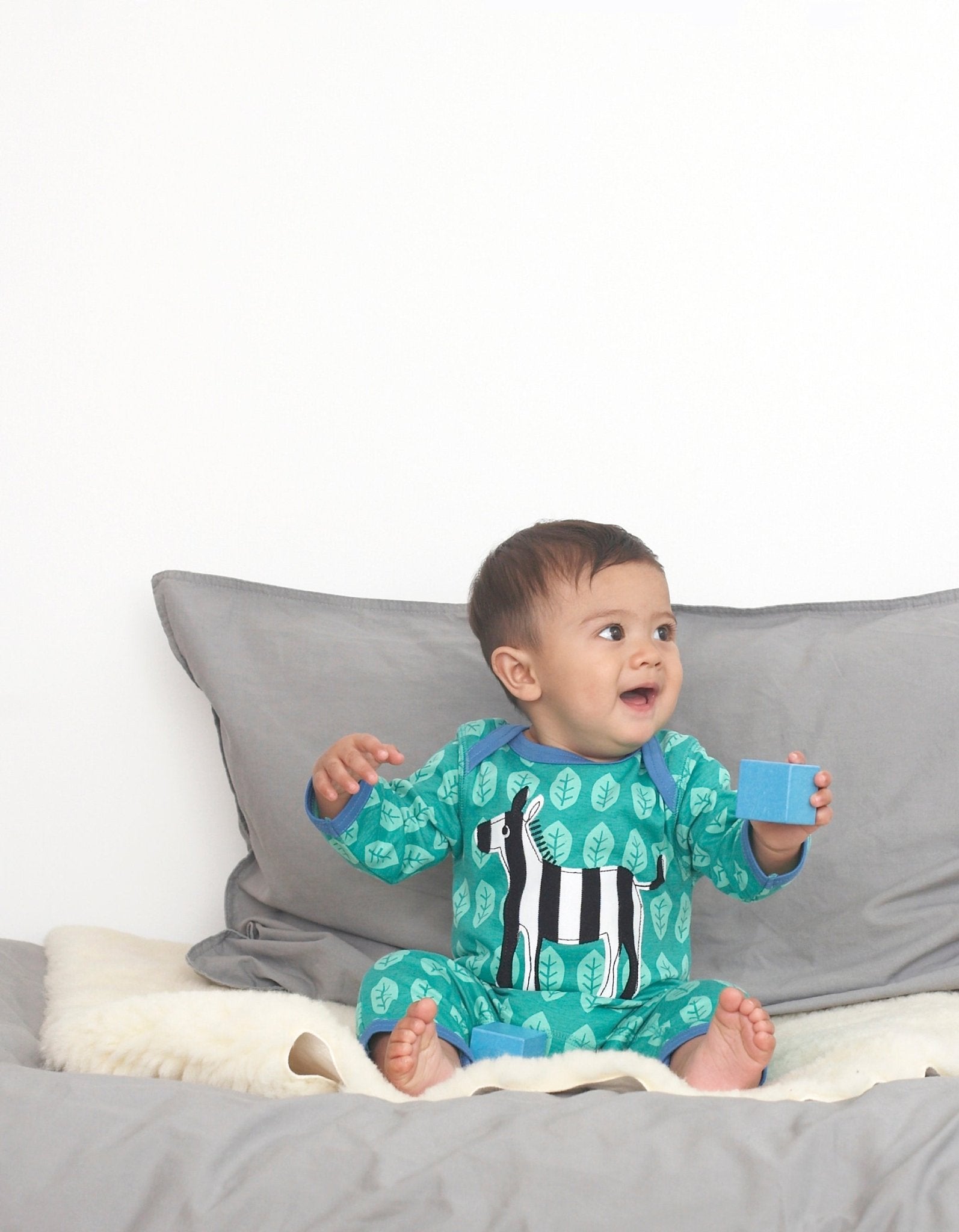 Playful Zebra Print Organic Cotton Sleepsuit with Slip Neck and Snap Buttons by Toby Tiger at brixbailey.com