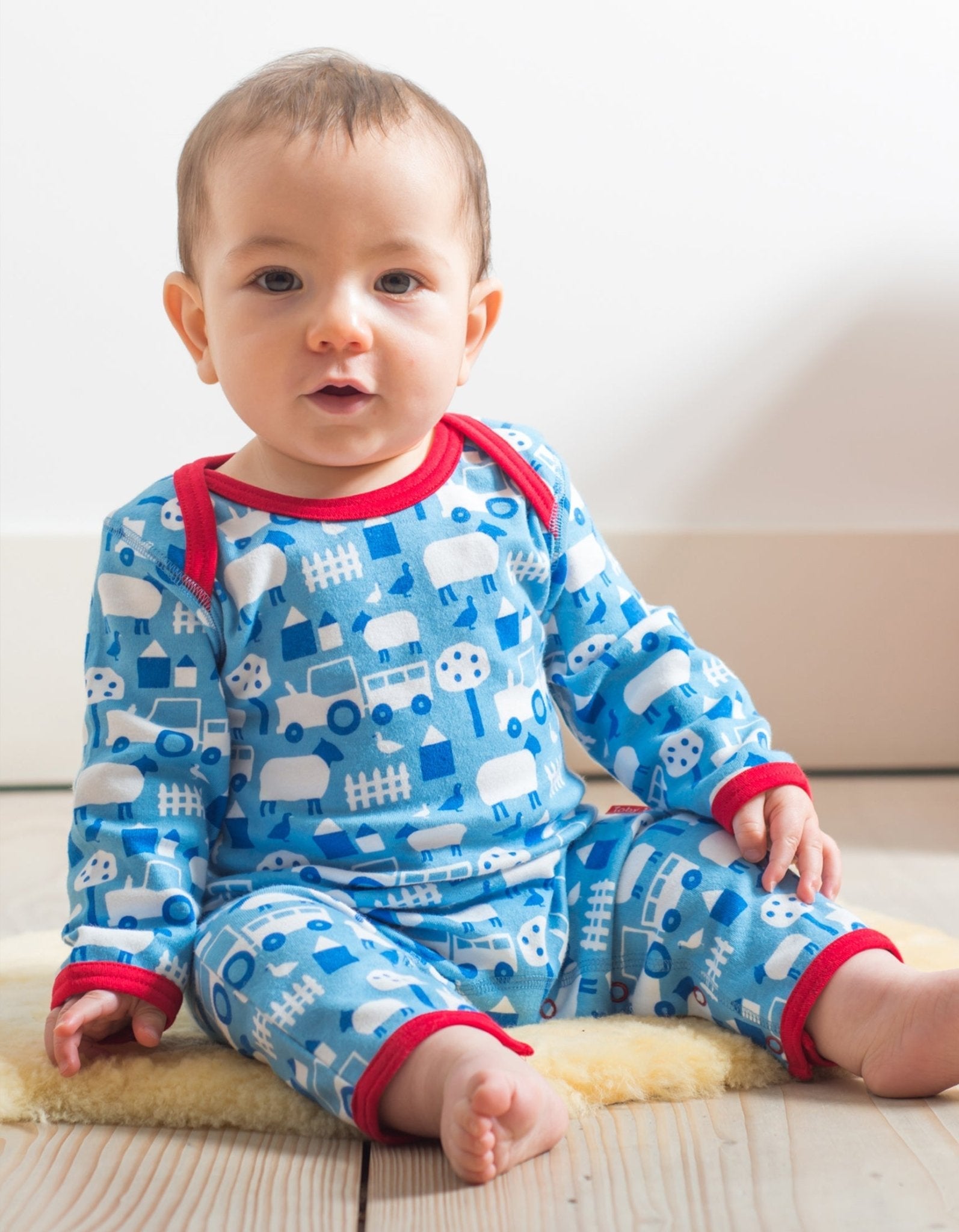 Premium baby sleepwear, organic cotton farm print pajamas, soft GOTS-certified, stylish Toby Tiger design, easy snap closure by Toby Tiger at brixbailey.com