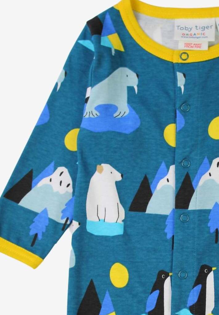 Premium blue organic cotton baby pajamas with arctic animals print, cozy yellow trim, snap buttons, closed feet by Toby Tiger at brixbailey.com