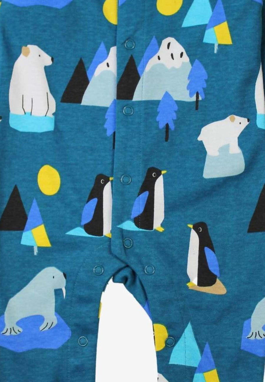 Premium blue Arctic print baby sleep suit with penguins, walruses, polar bears, icebergs, and mountains, soft organic cotton, snap buttons, footed pajamas by Toby Tiger at brixbailey.com