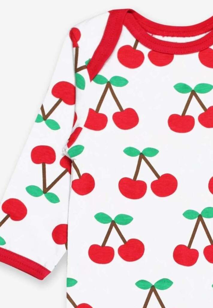 Premium organic cotton pajamas with cherry print, stylish red accents, slip-on neckline, snap buttons, soft GOTS-certified fabric by Toby Tiger at brixbailey.com