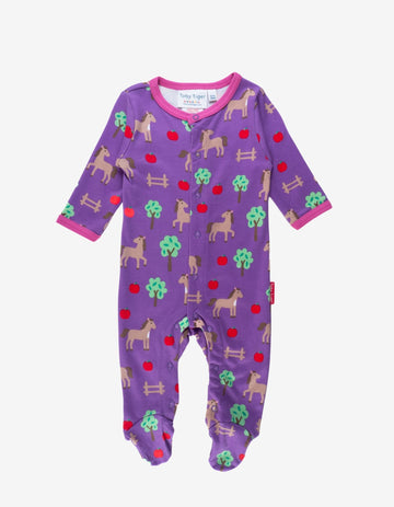 Premium organic cotton baby sleep suit with cozy horse and apple design, closed feet for warmth, GOTS certified by Toby Tiger at brixbailey.com