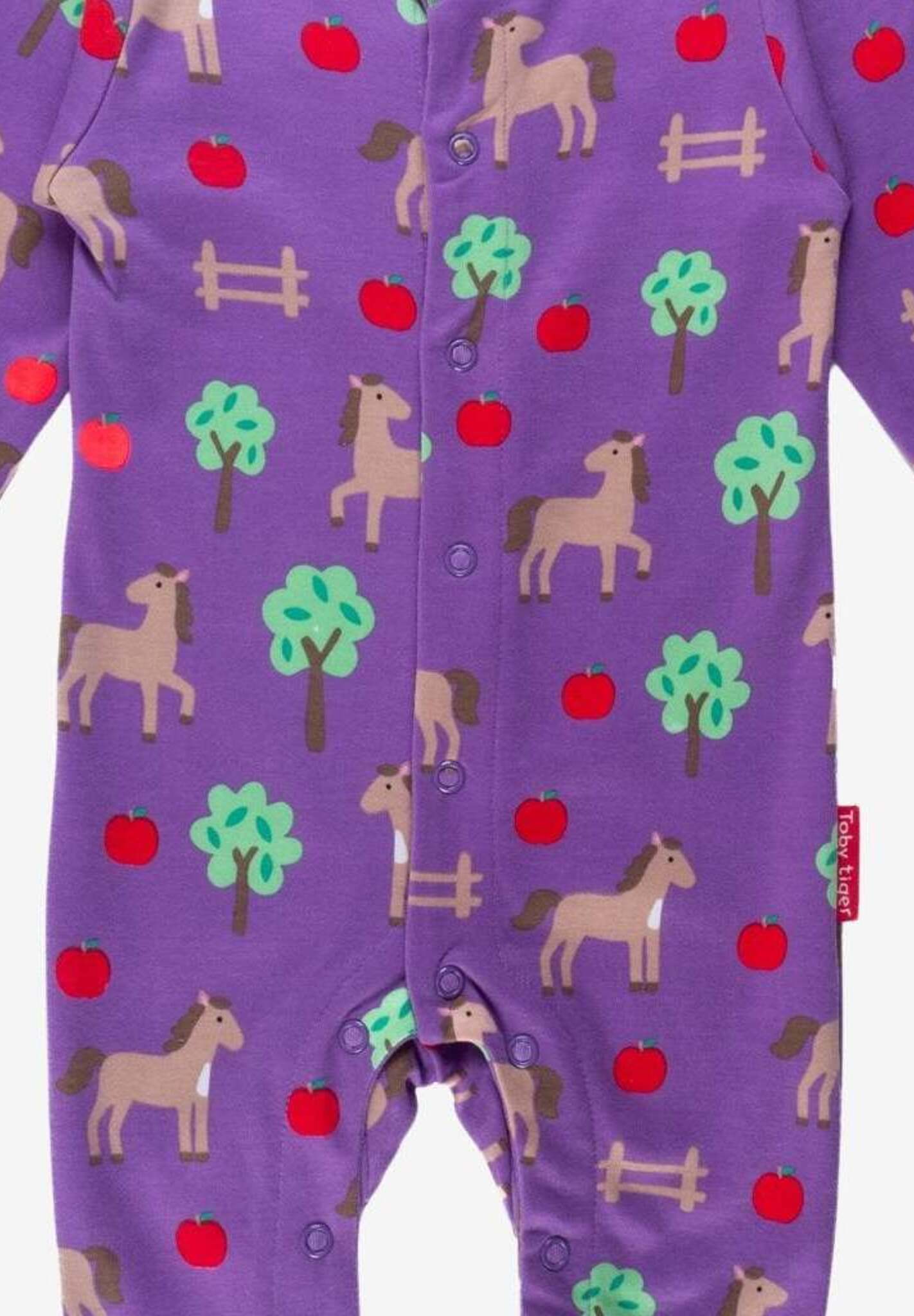 Premium organic cotton baby sleep suit with cozy horse and apple design, closed feet for warmth by Toby Tiger at brixbailey.com