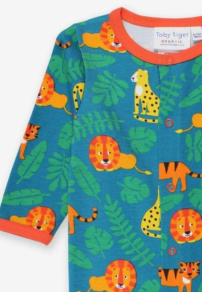 Premium baby lion print organic cotton pajamas, soft GOTS-certified sleepwear, stylish jungle-themed romper with snap buttons by Toby Tiger at brixbailey.com