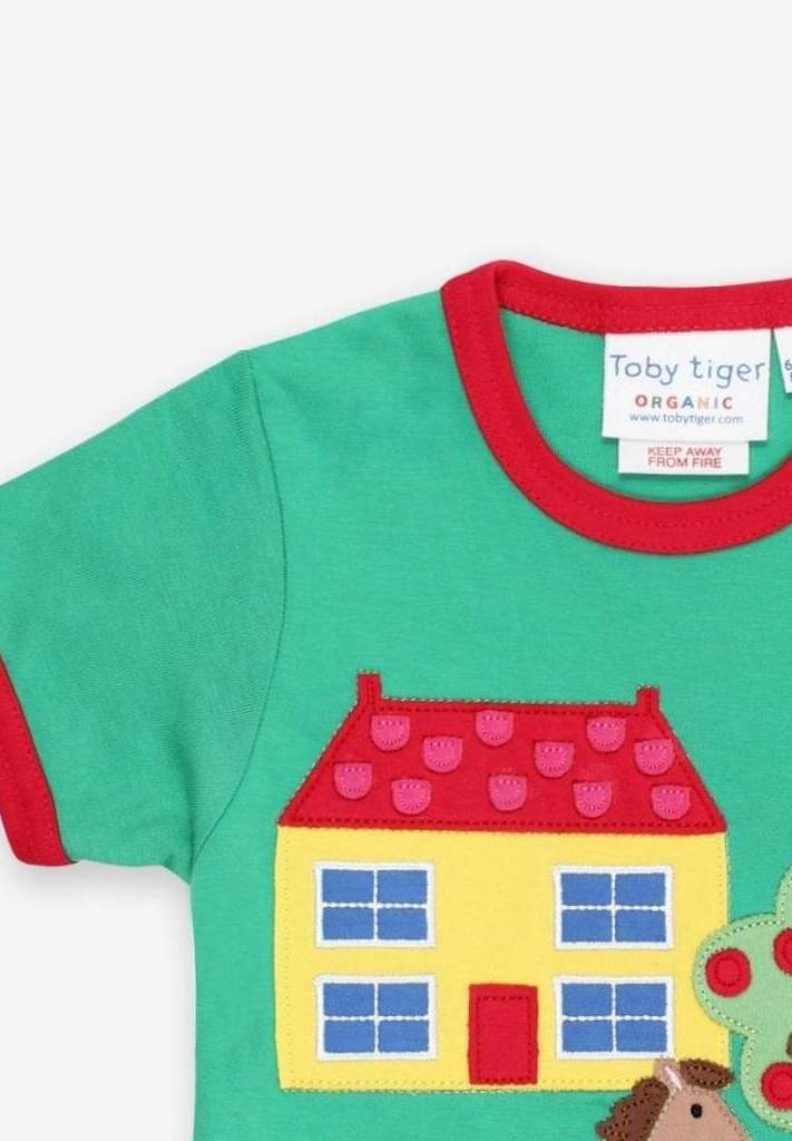 Stylish Green Organic Cotton T-Shirt with Farmhouse Applique, Red Trim, and Snap Buttons for Easy Dressing by Toby Tiger at brixbailey.com