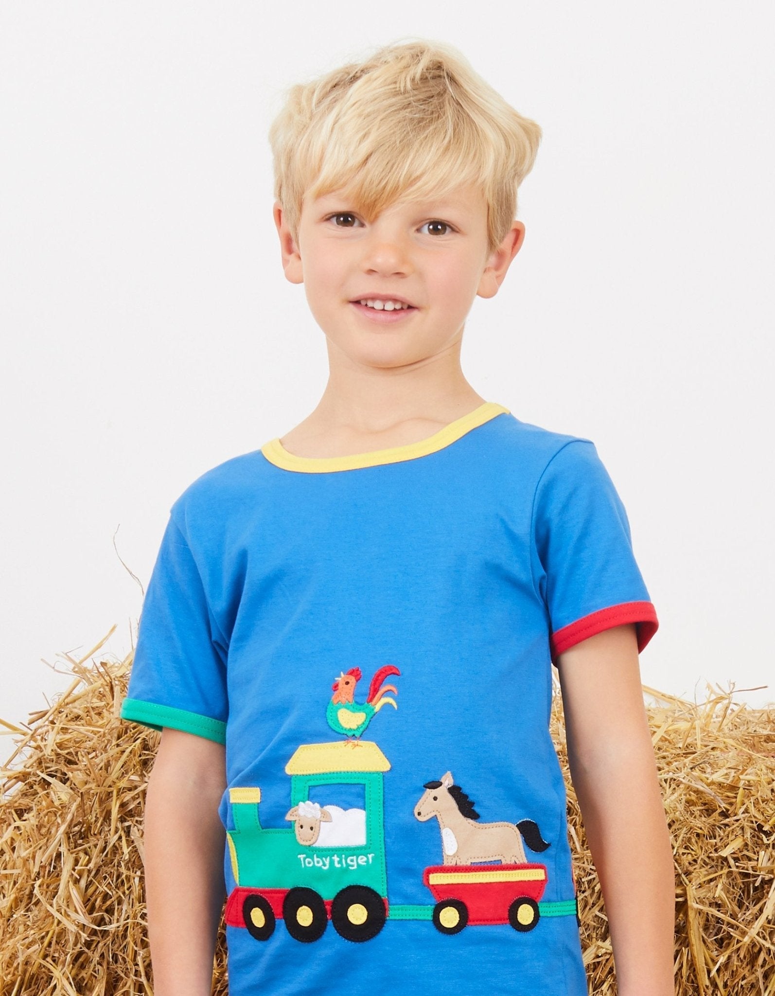Premium organic cotton kids train applique t-shirt, soft GOTS-certified fabric, snap buttons for easy dressing, stylish summer outfit by Toby Tiger at brixbailey.com