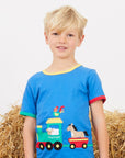 Premium organic cotton kids train applique t-shirt, soft GOTS-certified fabric, snap buttons for easy dressing, stylish summer outfit by Toby Tiger at brixbailey.com