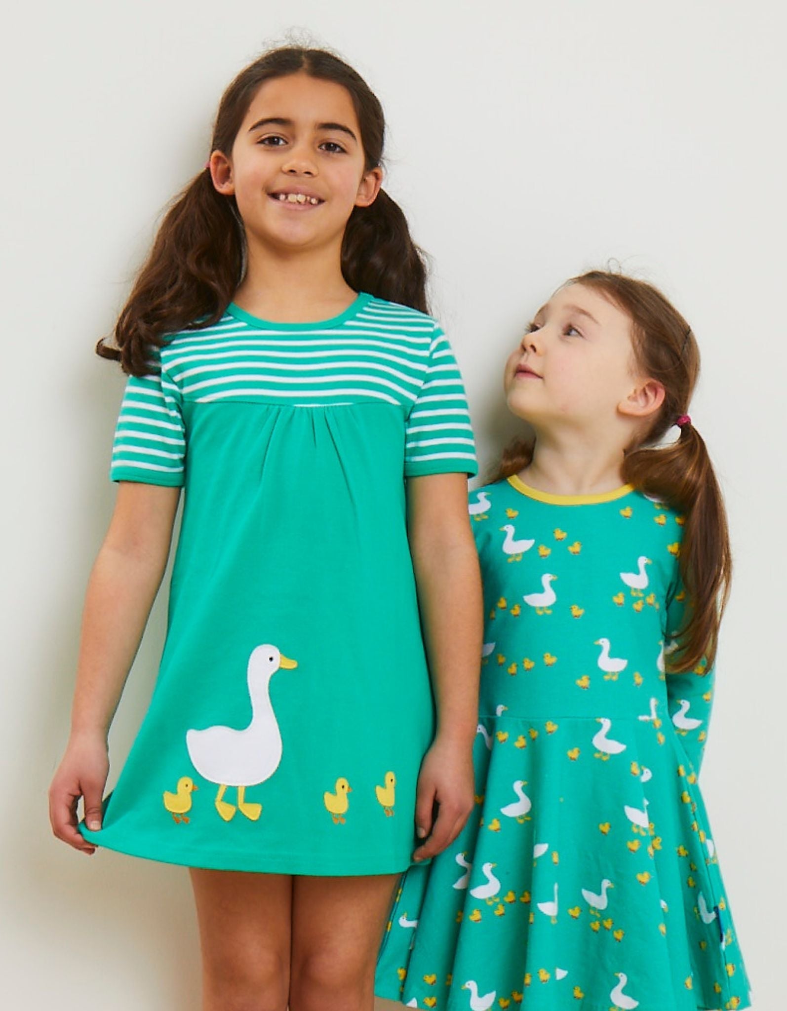 Bright green organic cotton kids t-shirt dress with duck applique and cute chicks, stylish contrasting stripes, snap neck closure by Toby Tiger at brixbailey.com