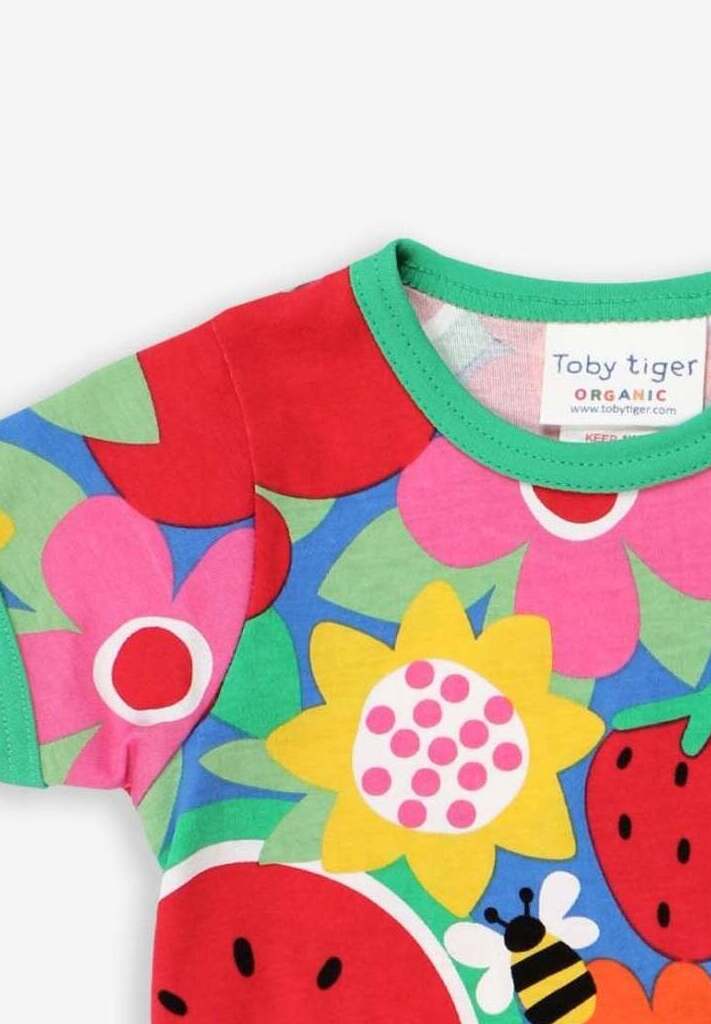 Premium baby short sleeve t-shirt with floral fruit print, soft organic cotton, snap button neck, stylish green trim, sustainable kids fashion by Toby Tiger at brixbailey.com