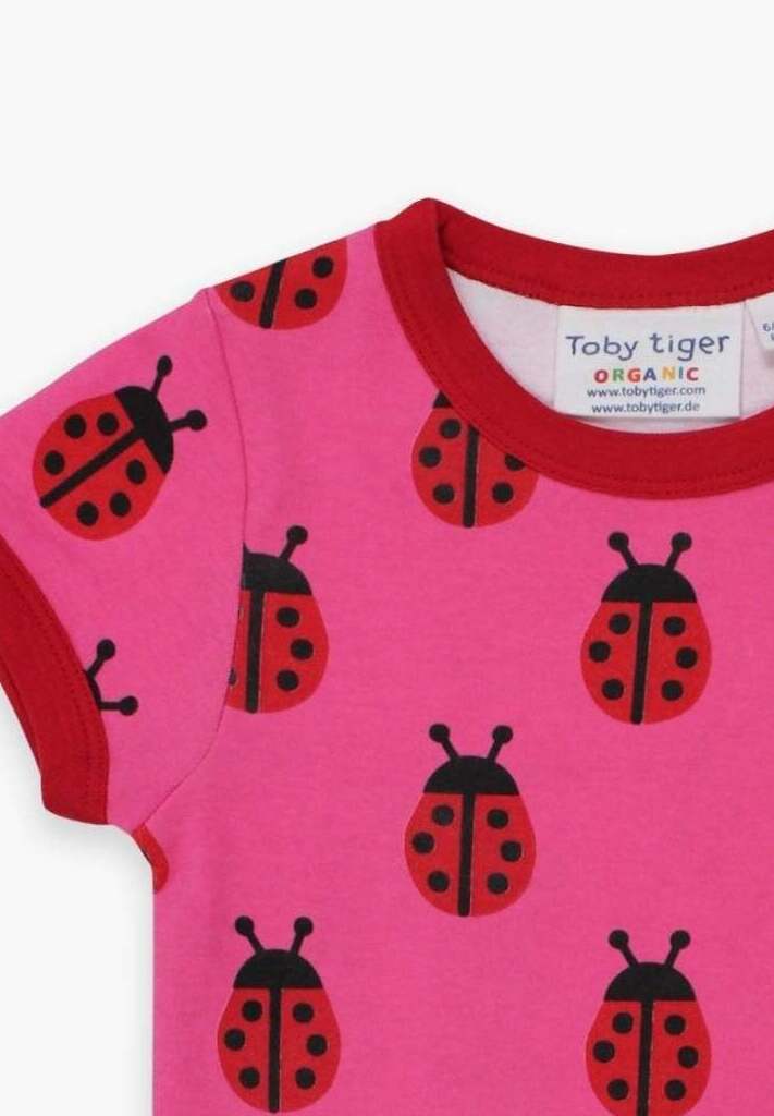 Premium Pink Ladybug Print Baby T-Shirt with Red Trim, Snap Buttons, 100% GOTS Certified Organic Cotton by Toby Tiger at brixbailey.com