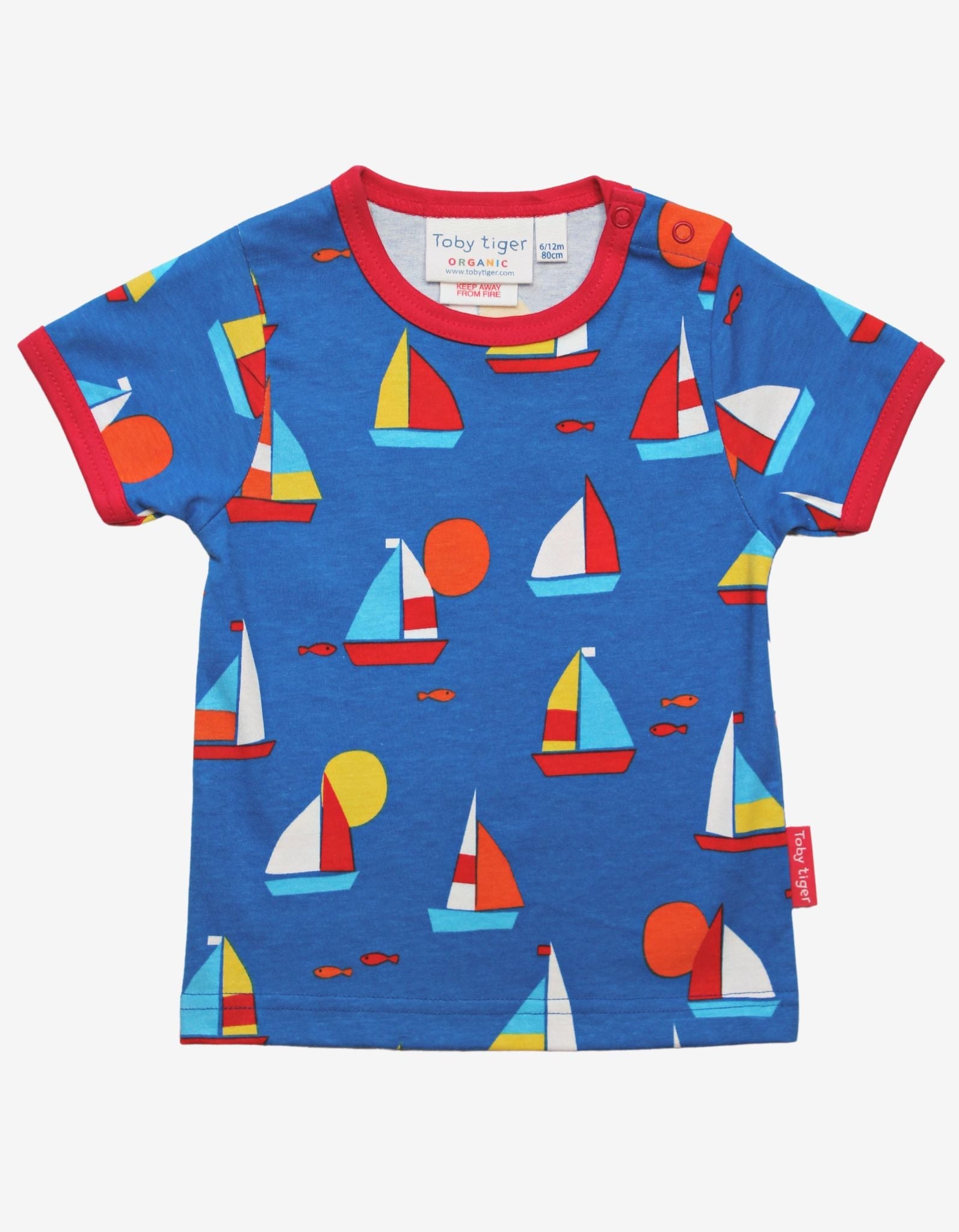 Premium kids organic cotton t-shirt with sailboat print, stylish red trim, deep blue background, playful fish details, GOTS certified, easy snap neck closure by Toby Tiger at brixbailey.com