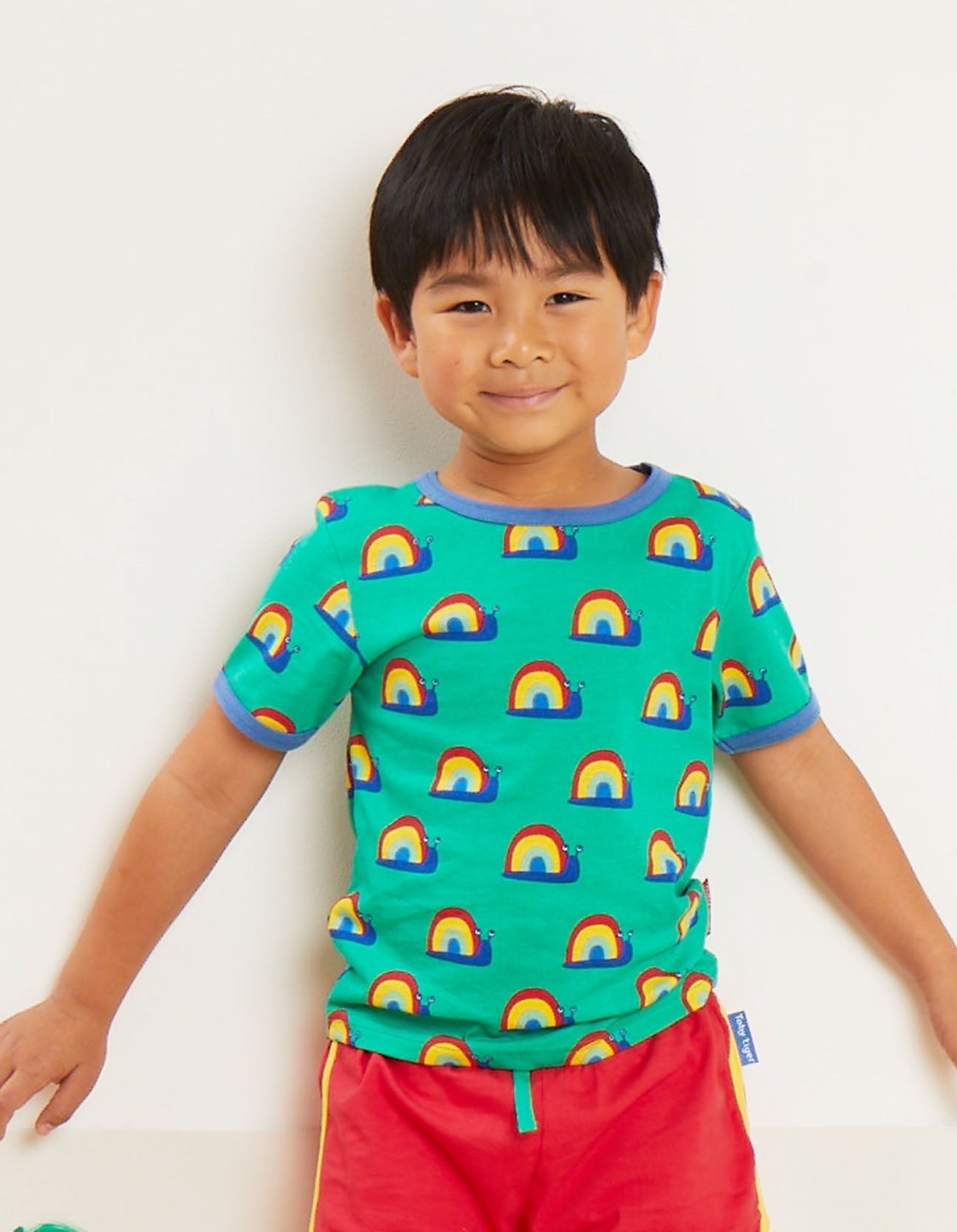 Premium baby t-shirt with colorful snail print, soft organic cotton, snap-button neck, eco-friendly dyes, sizes 3-24 months by Toby Tiger at brixbailey.com
