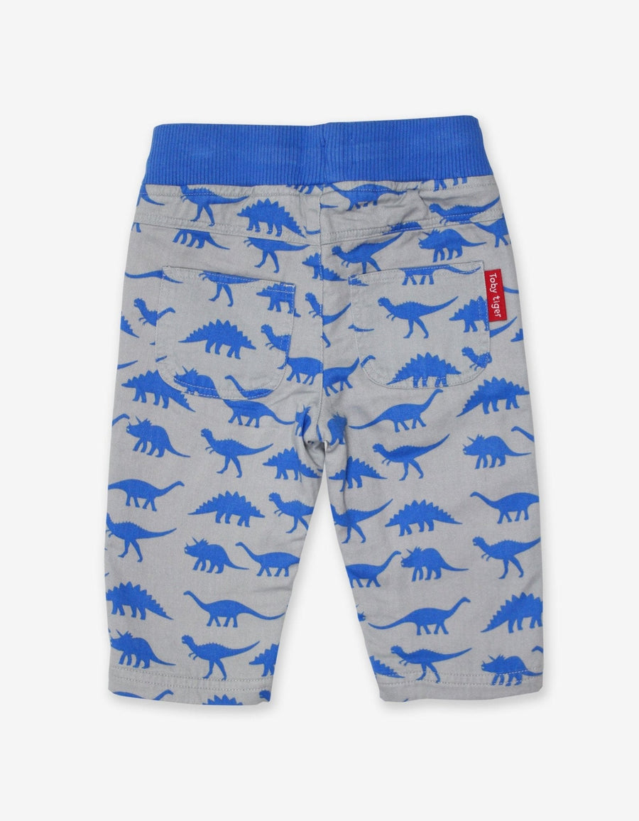 Premium baby cotton pants with playful dinosaur print, soft elastic waistband, cozy jersey lining, machine washable by Toby Tiger at brixbailey.com
