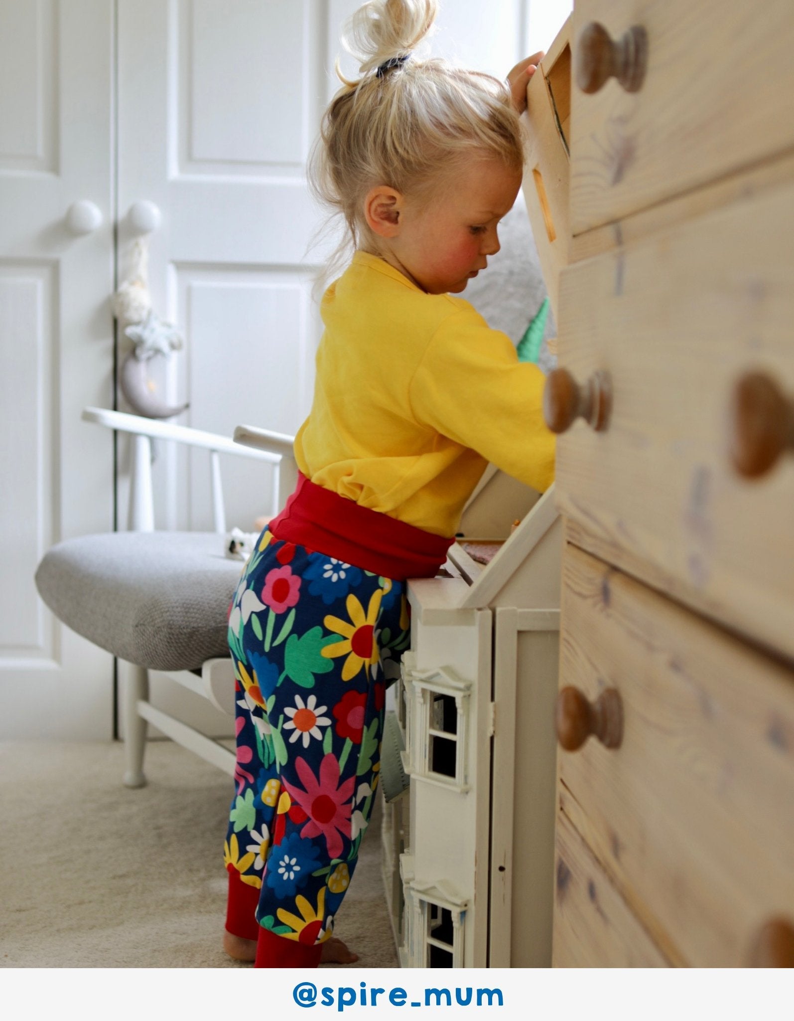 Premium organic cotton kids yoga pants with floral print, dark blue with snowdrops daisies and tulips, soft comfortable waistband and cuffs, GOTS certified by Toby Tiger at brixbailey.com