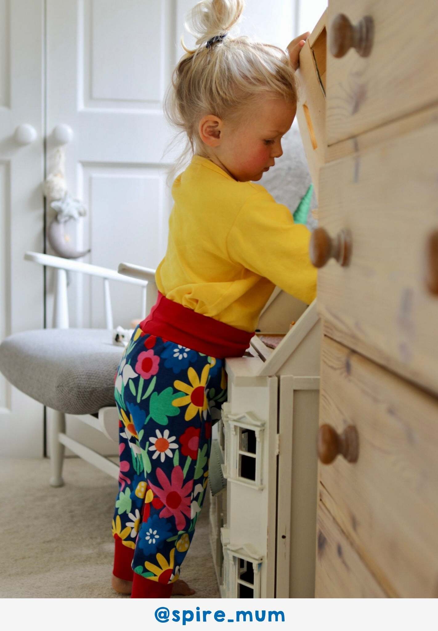 Premium organic cotton kids yoga pants with bold floral print, dark blue with snowdrops daisies and tulips, comfortable waistband and cuffs by Toby Tiger at brixbailey.com