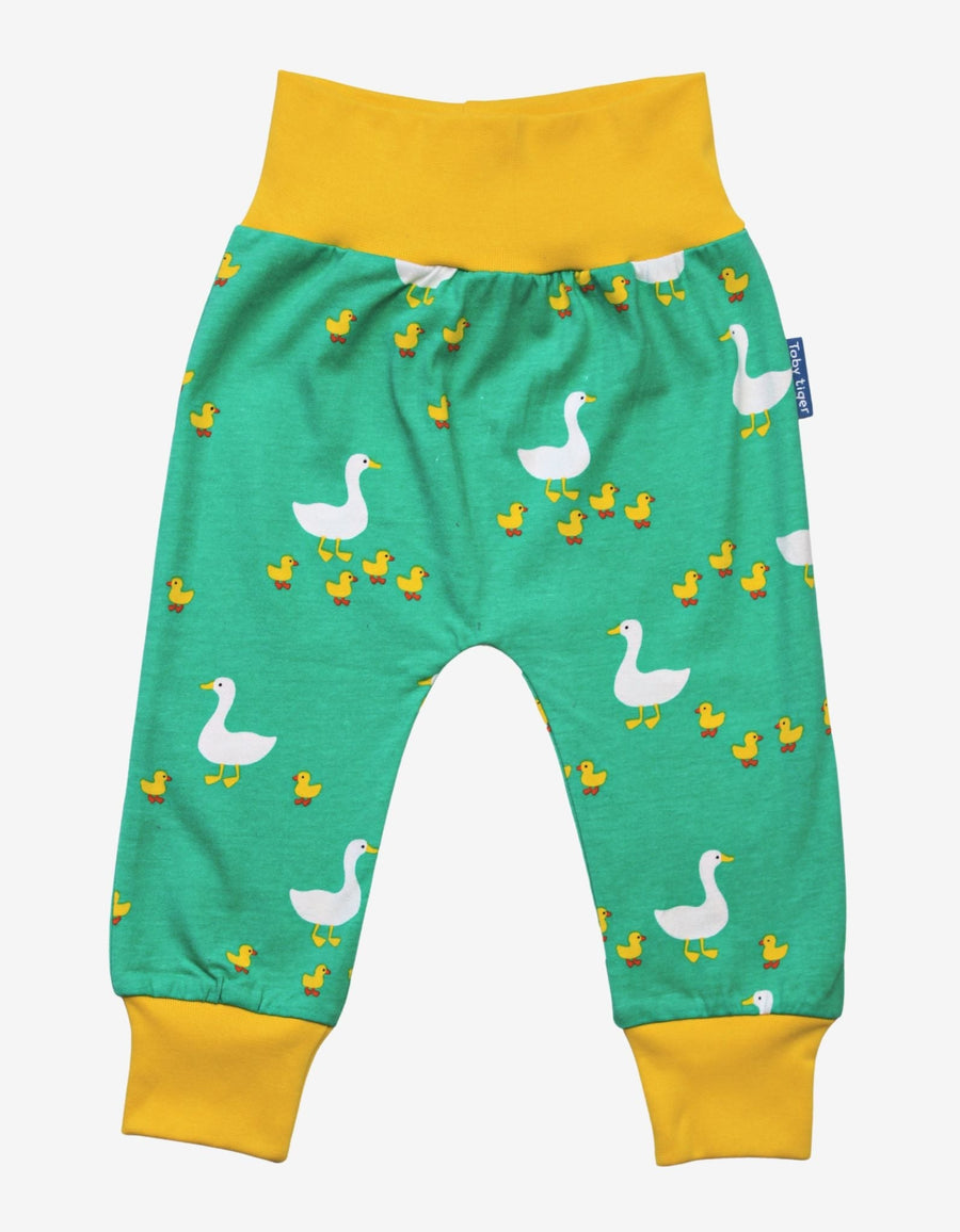 Premium organic cotton kids yoga pants with duck print, playful green and yellow design, soft GOTS-certified fabric, comfortable waistband and cuffs by Toby Tiger at brixbailey.com