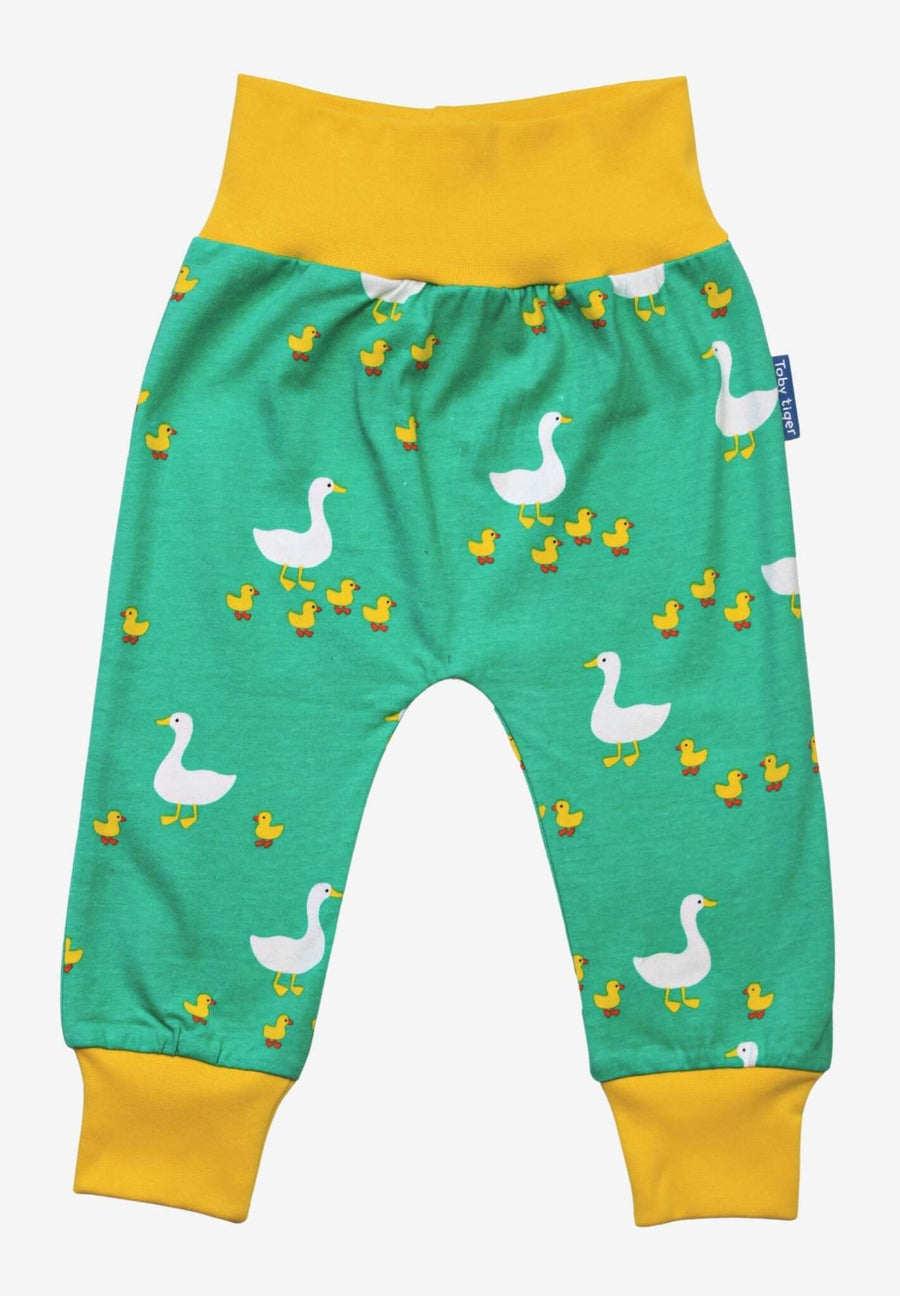 Premium organic cotton kids yoga pants with duck print, soft GOTS-certified fabric, playful green and yellow design, comfortable waistband and cuffs by Toby Tiger at brixbailey.com