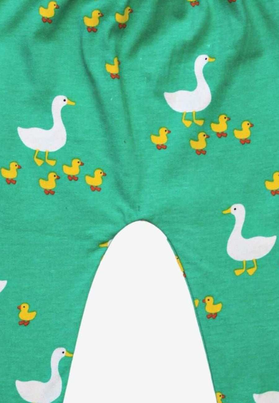 Premium organic cotton kids yoga pants with duck print, playful green and yellow, soft GOTS-certified fabric, comfortable waistband and cuffs by Toby Tiger at brixbailey.com