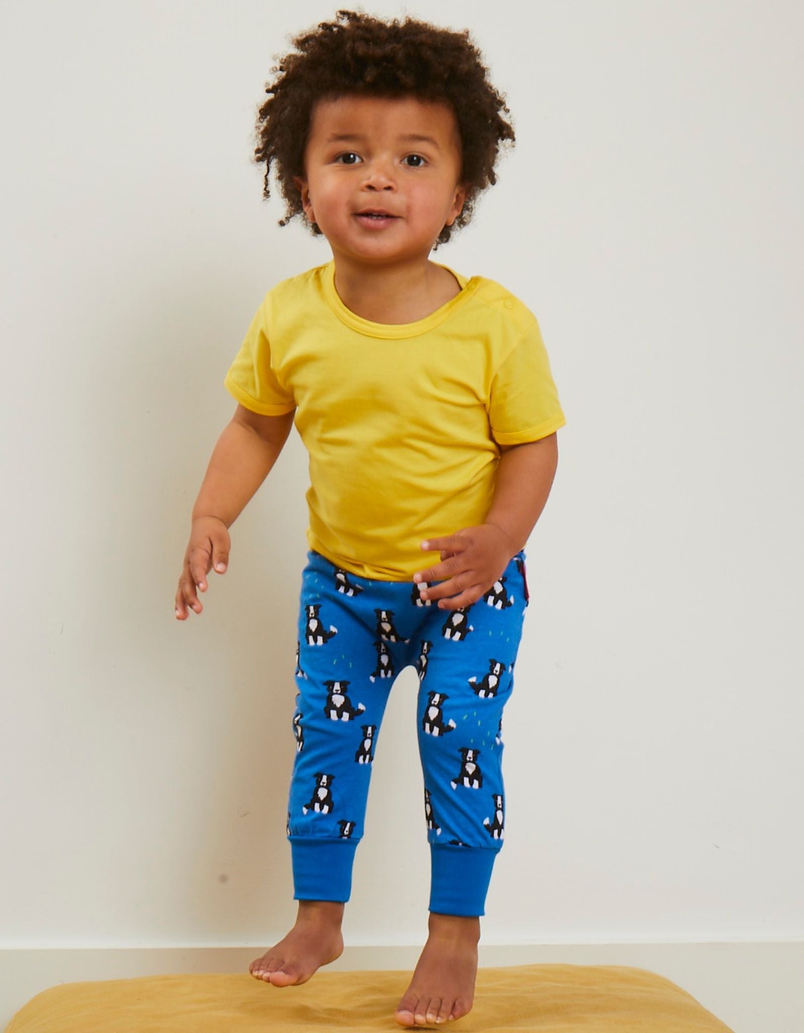 Premium organic cotton yoga pants with dog print, stylish and comfortable for kids, eco-friendly GOTS certified, wide ankle cuffs, farm-themed collection by Toby Tiger at brixbailey.com