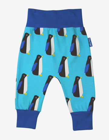 Premium baby blue organic cotton yoga pants with penguin print, elastic waistband, ankle cuffs, soft GOTS-certified fabric by Toby Tiger at brixbailey.com