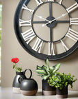 Black Skeleton Clock with White Roman Numerals