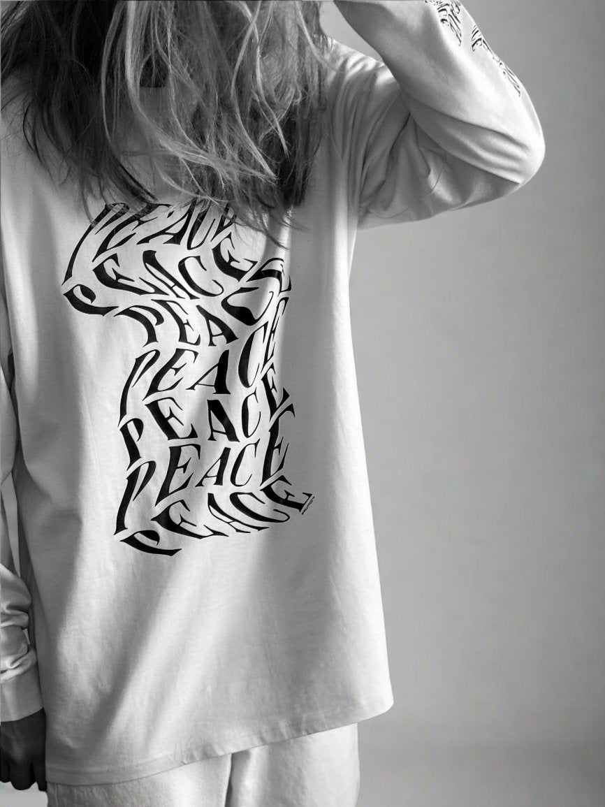 Luxury oversized off-white long sleeve with matte black graphics, premium 200 gsm organic cotton, handcrafted limited edition unisex top by WWOOLLFF CO. at brixbailey.com